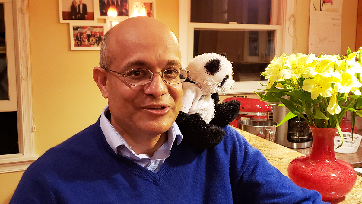 Paul Almeida with stuffed panda bear Chunky on his shoulder