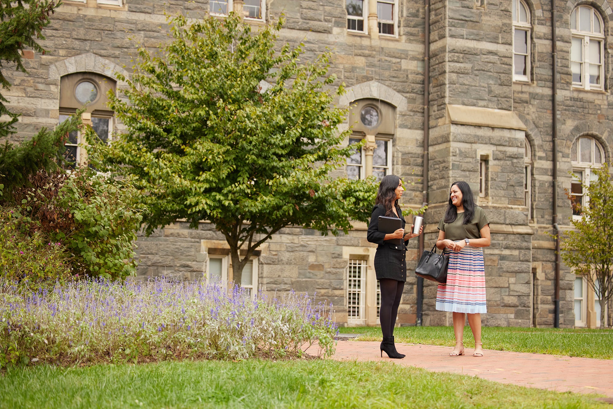 2 IBP students talking near Healy hall