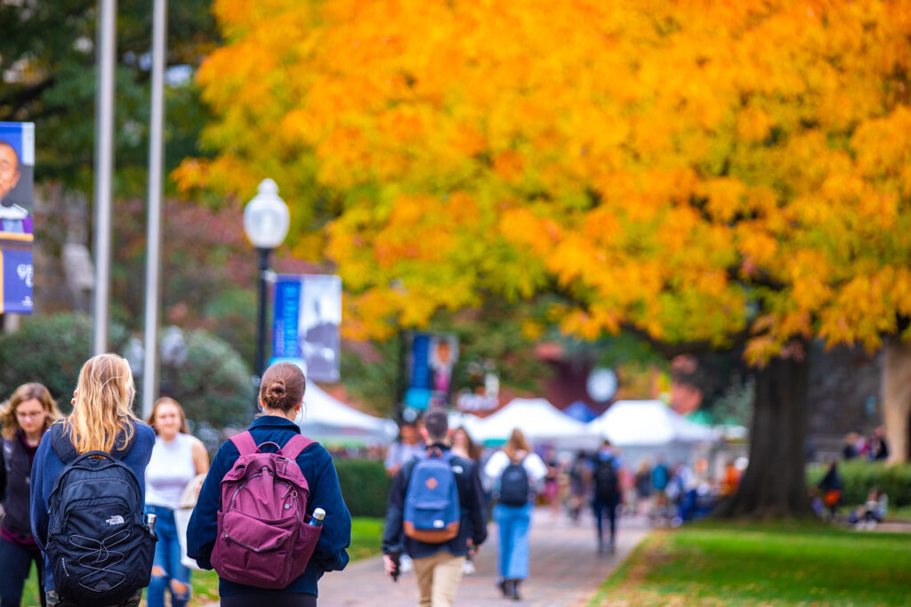 students walking on healy lawn in the fall