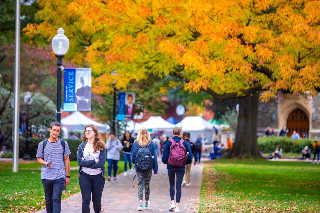students walking on healy lawn in fall