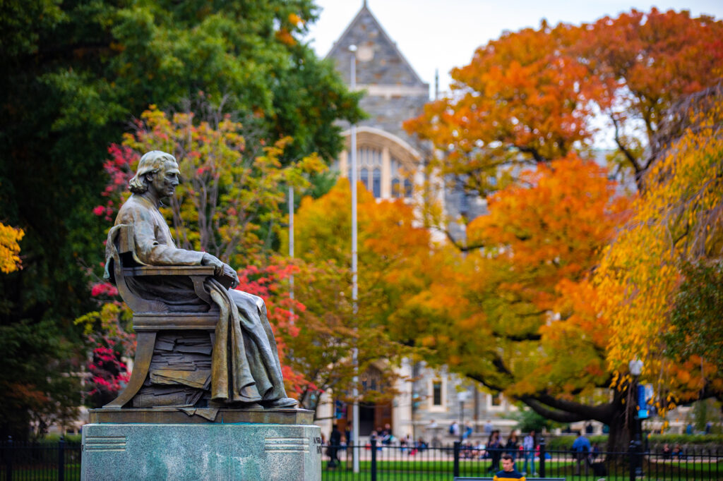 john carrol statue on georgetown campus in the fall