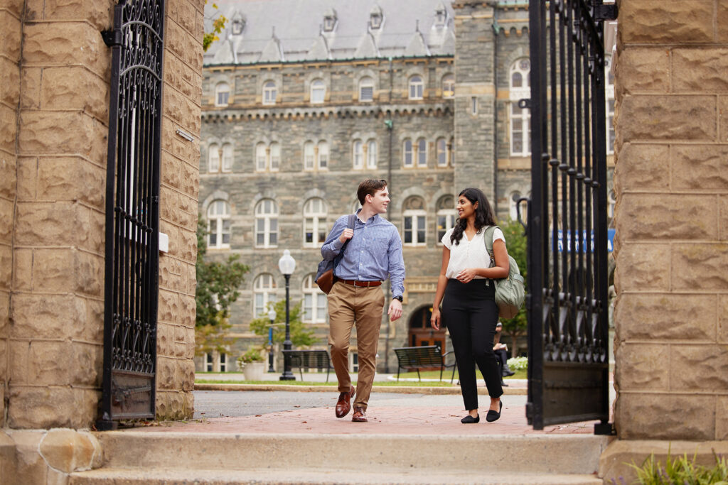 two students walking through the Georgetown University campus gates