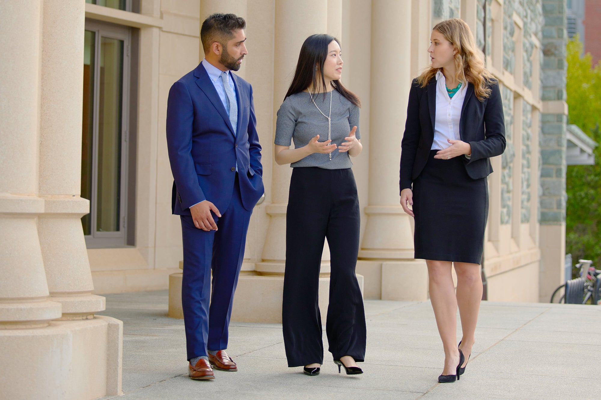 MBA students walking on the front steps of Hariri