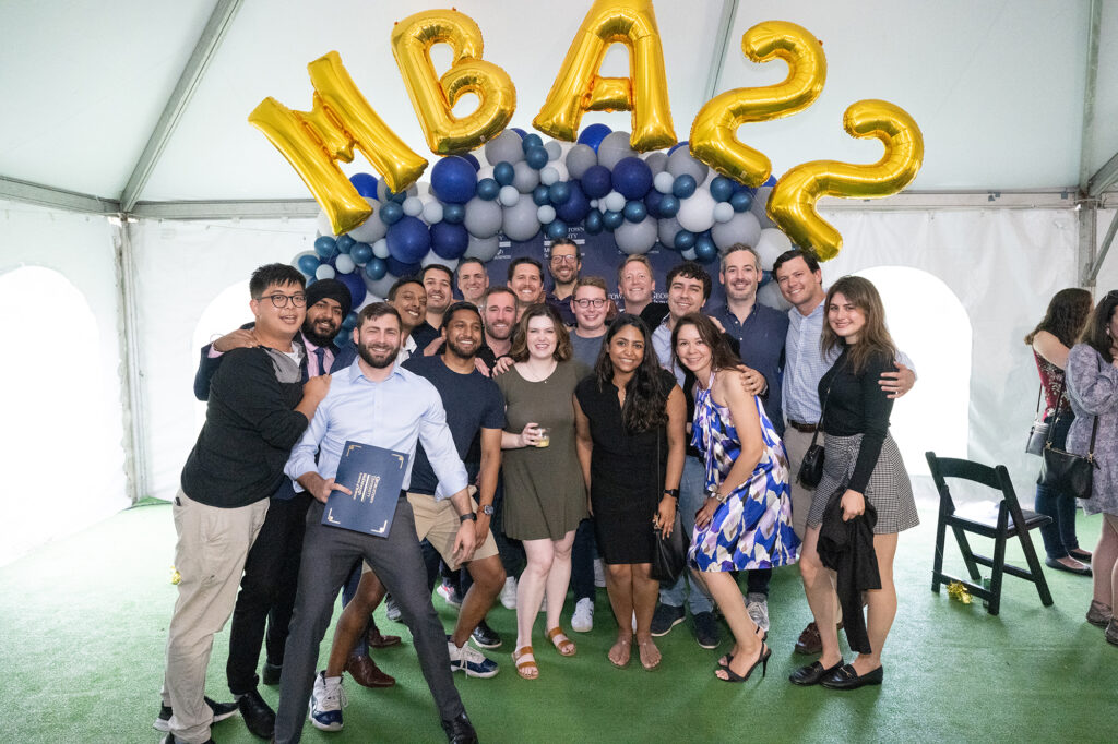 Group of MBA 2022 students under balloon arch