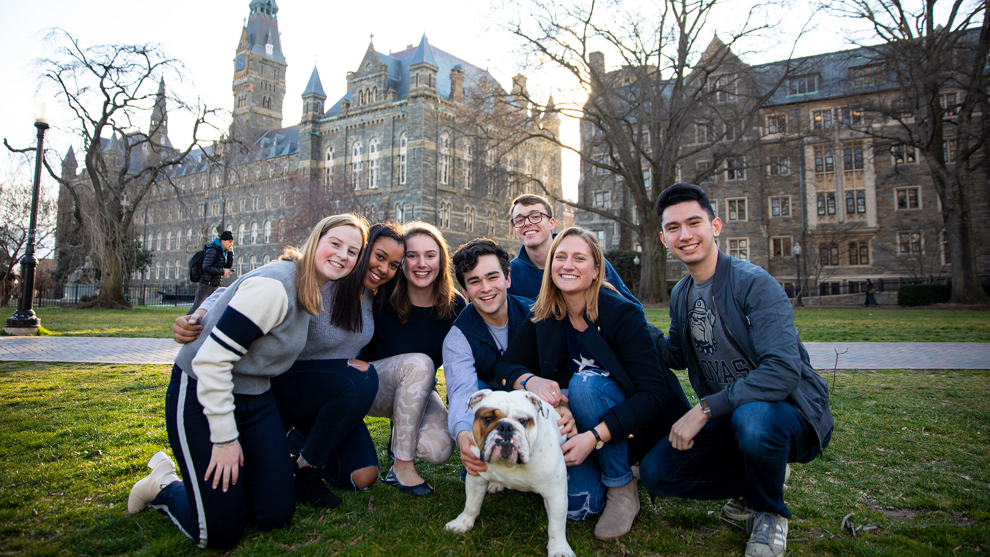Undergrad students posing with Jack the Bulldog in front of Healy Hall on Georgetown University campus
