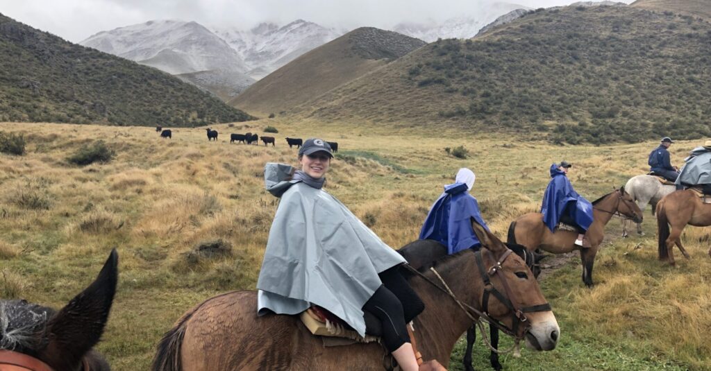 Undergraduate student riding donkey in the mountains