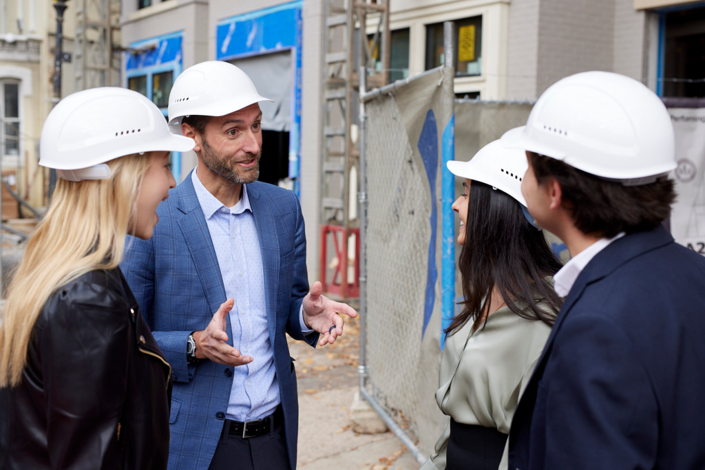 Professor Matthew Cypher speaking to Georgetown McDonough students at a construction site.