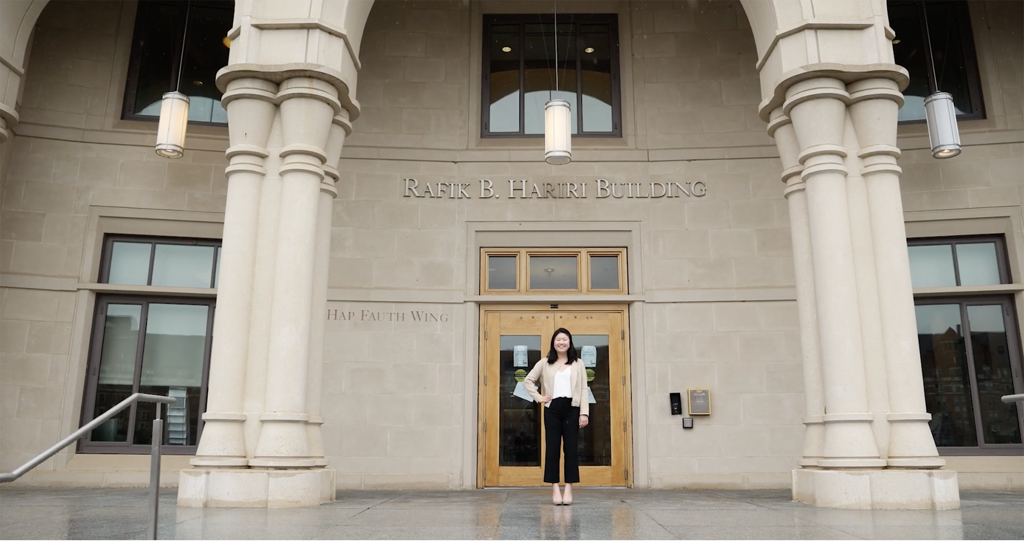 student standing in front of hariri building