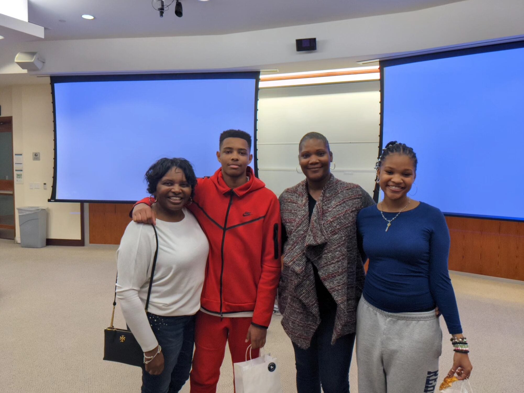 Reach students a classroom with two screens behind them
