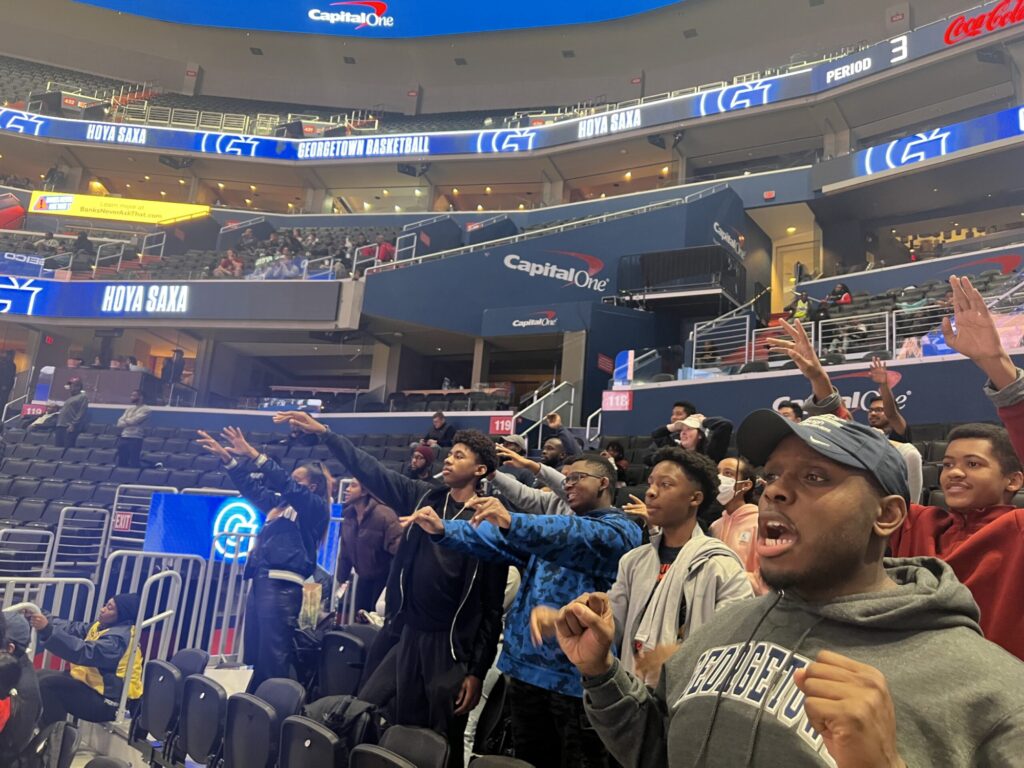 Reach students cheering at a Georgetown University basketball game in the Capitol One Arena