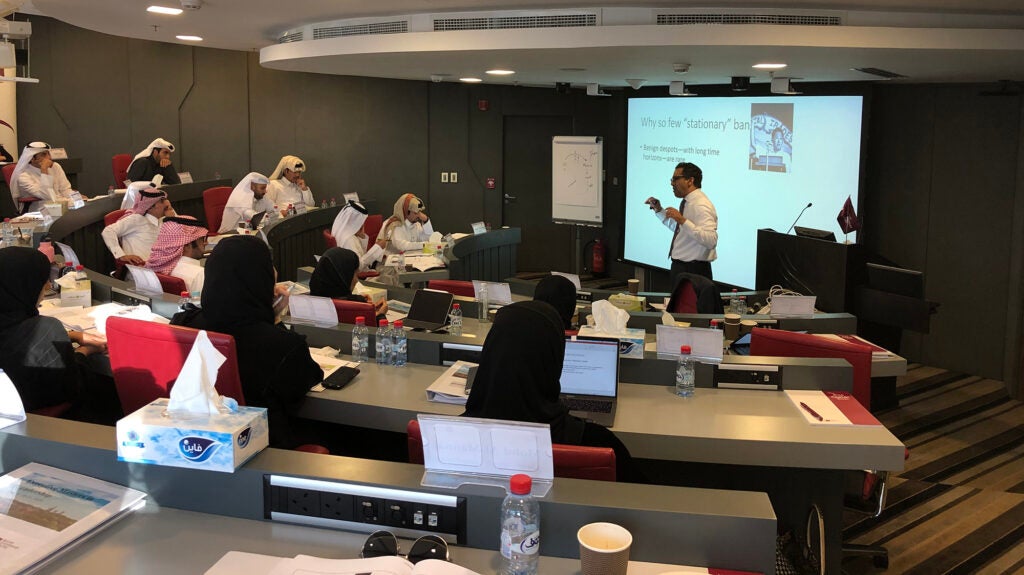 Executive Masters in Leadership Qatar program students sitting in lecture hall while professor teaches about finance