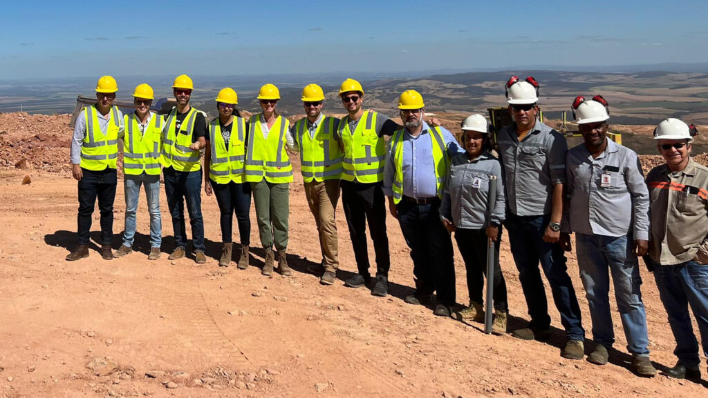 EMBA Students in construction outfits standing in the desert