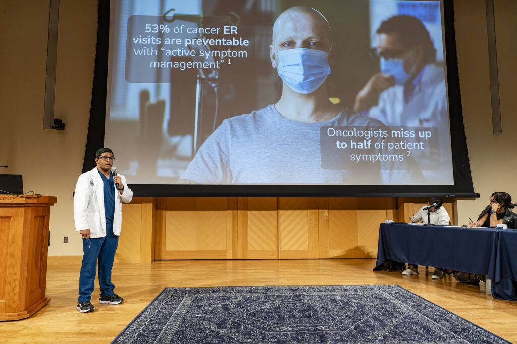 student presenting during a pitch competition about a business of healthcare problem