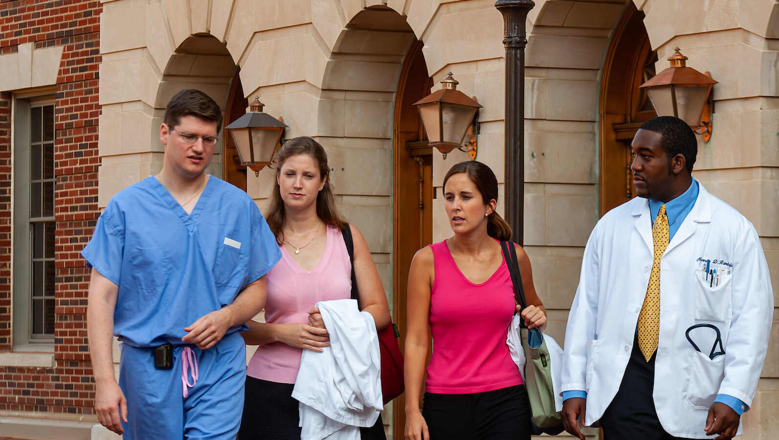 healthcare workers and business people walking side by side