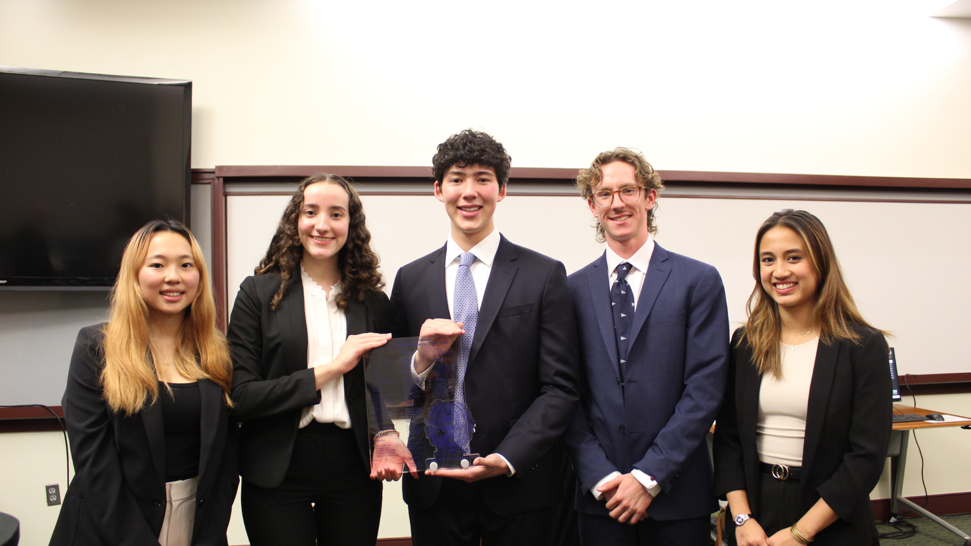Undergraduate students celebrate a win in the case competition