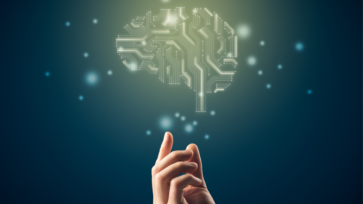 A hand gestures towards a digital image of the brain, conveying the function of artificial intelligence (AI).