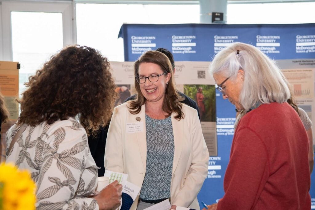 MS-ESM Program Director Kerrie Carfagno welcomes the guests into the poster session. 