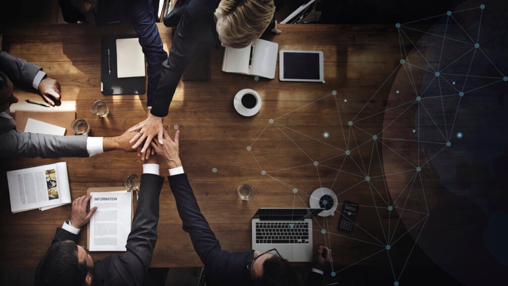 hands across a table doing business