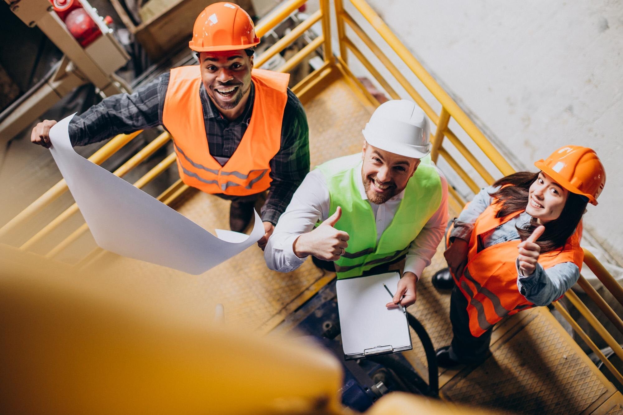 Three happy people at a construction site