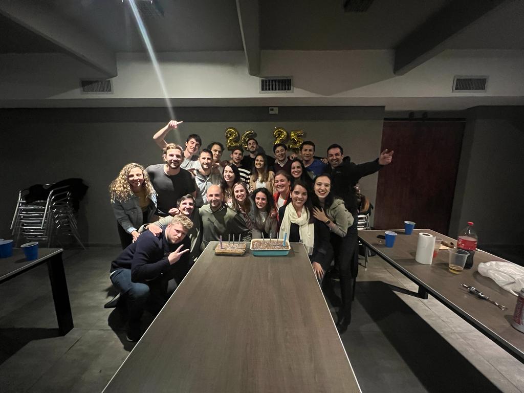 group of students in front of cake in Argentina