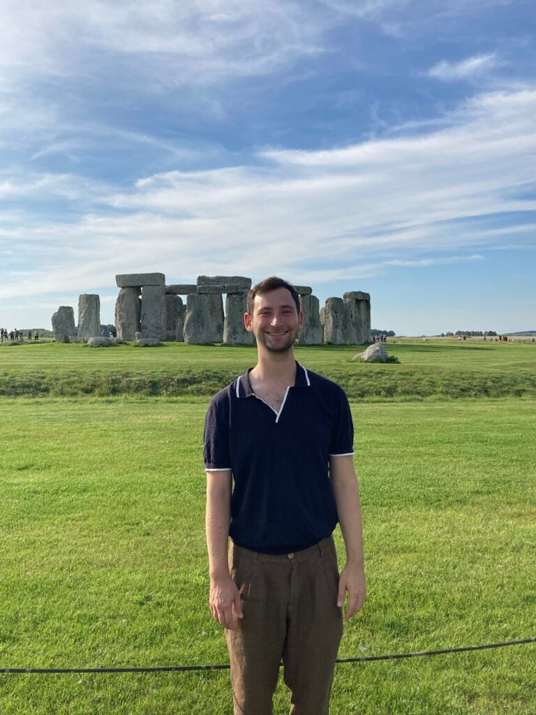 student standing in front of Stonehenge