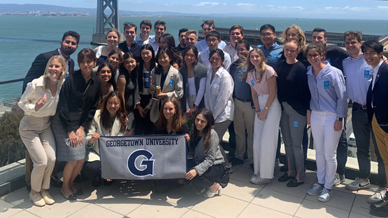 a big group of undergraduate students having fun and showing pride on a trip abroad