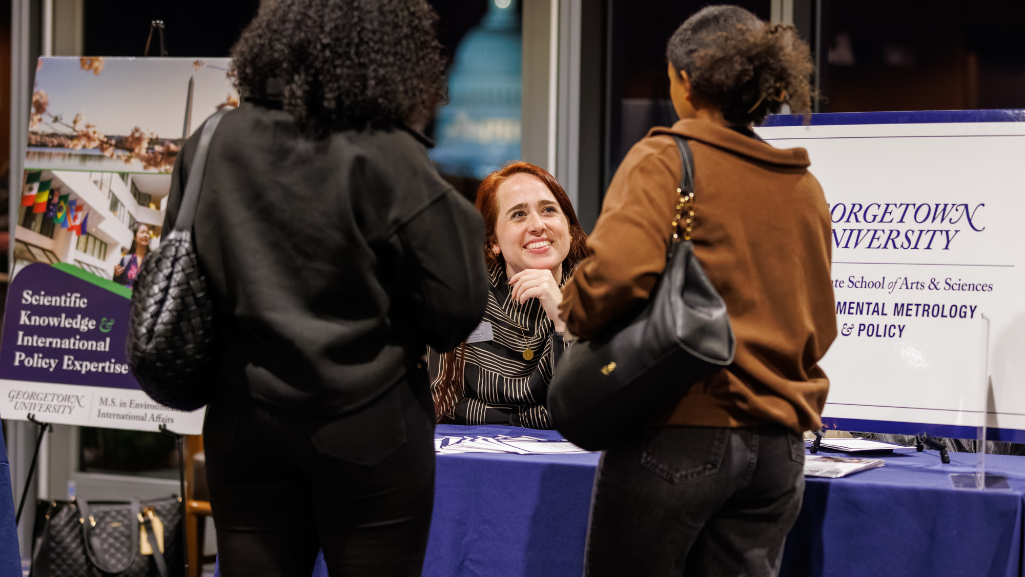 An admissions rep speaks to prospective students at the inaugural DMV Sustainability Fair, organized by Georgetown's MS-ESM program