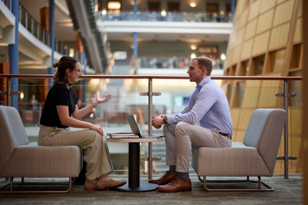 student and staff talking in Georgetown building