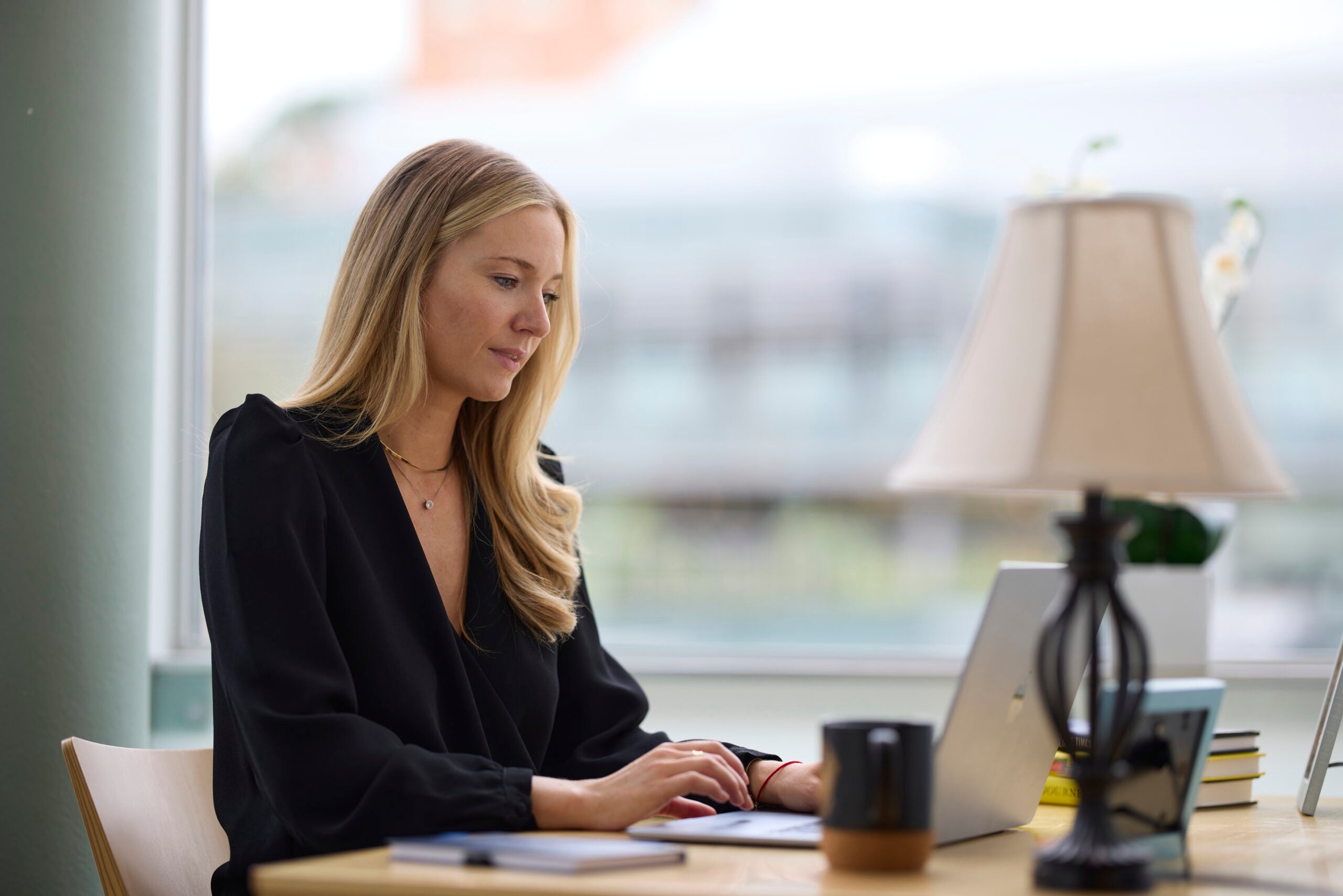 Woman seated at desk taking a class online