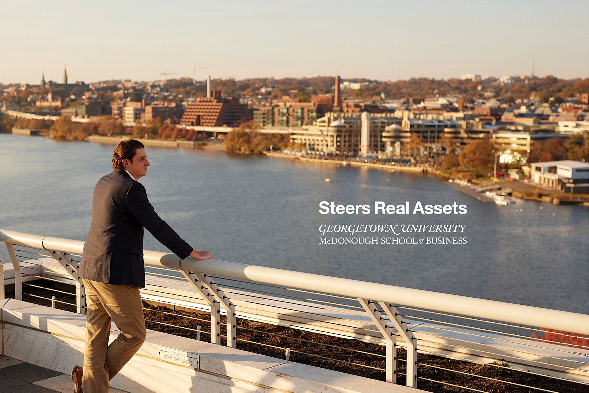 man standing looking over a river with the logo for the Steers Real assets logo overlaid