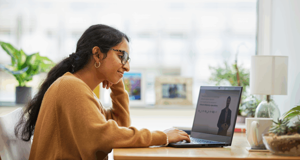 A M.S.F. student wearing glasses studies on a laptop