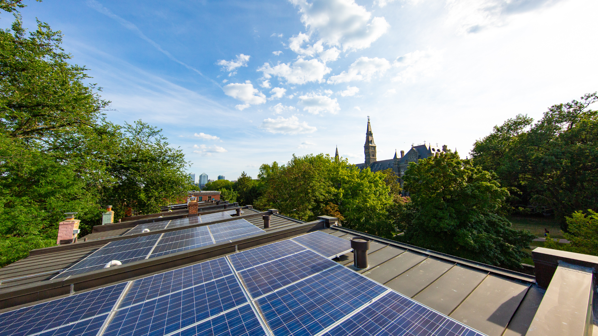 Solar panels on top of row houses with Georgetown University Healy Hall