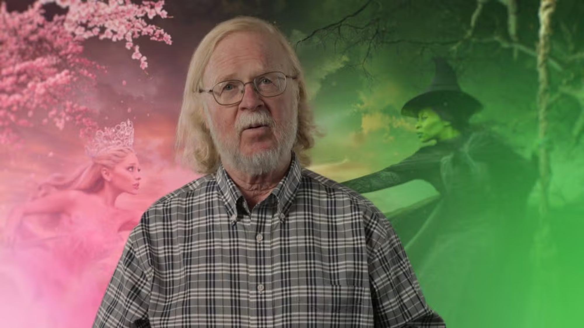 Bob Bies in front of a Wicked movie poster