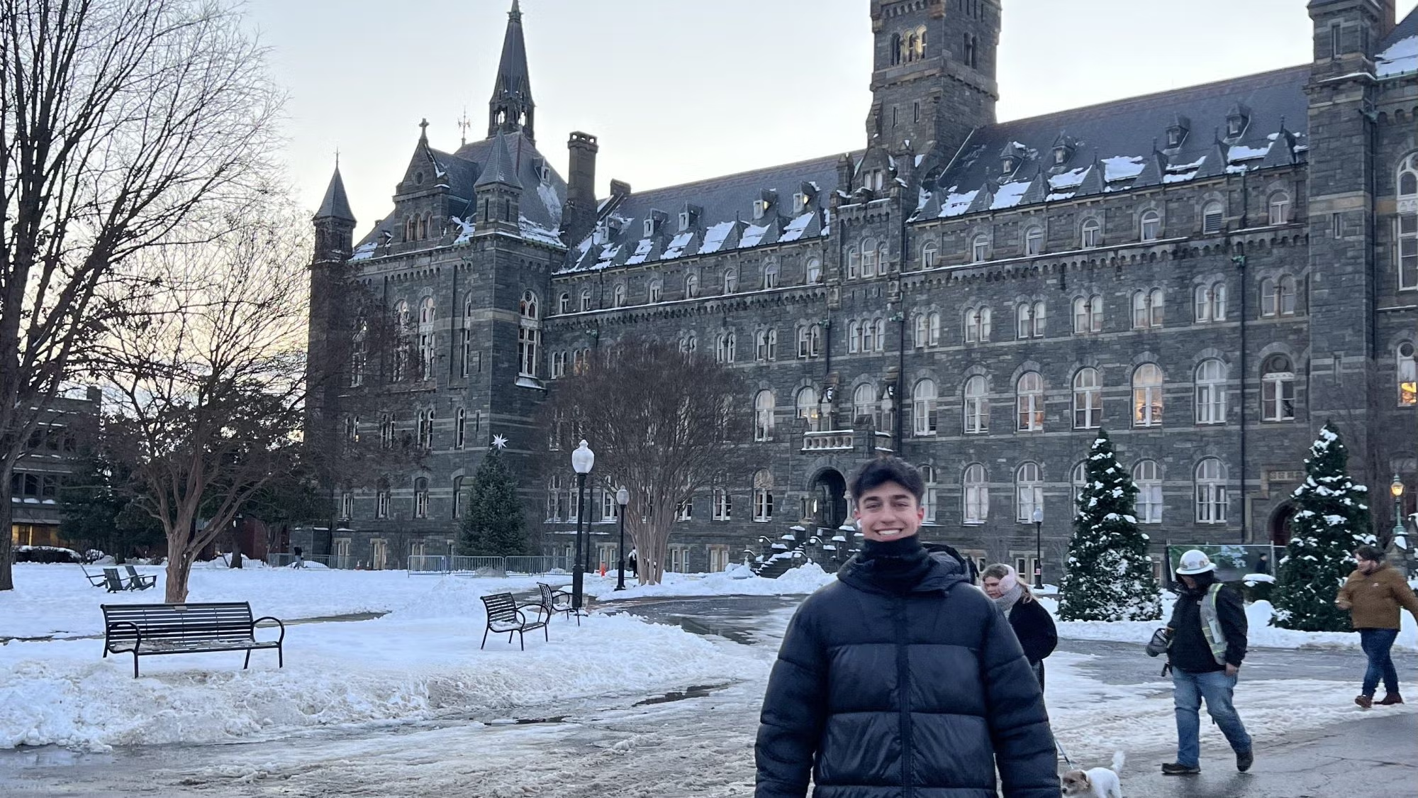 Kiumars Afrassiabi (B'28) in front of a snowy Healy Hall