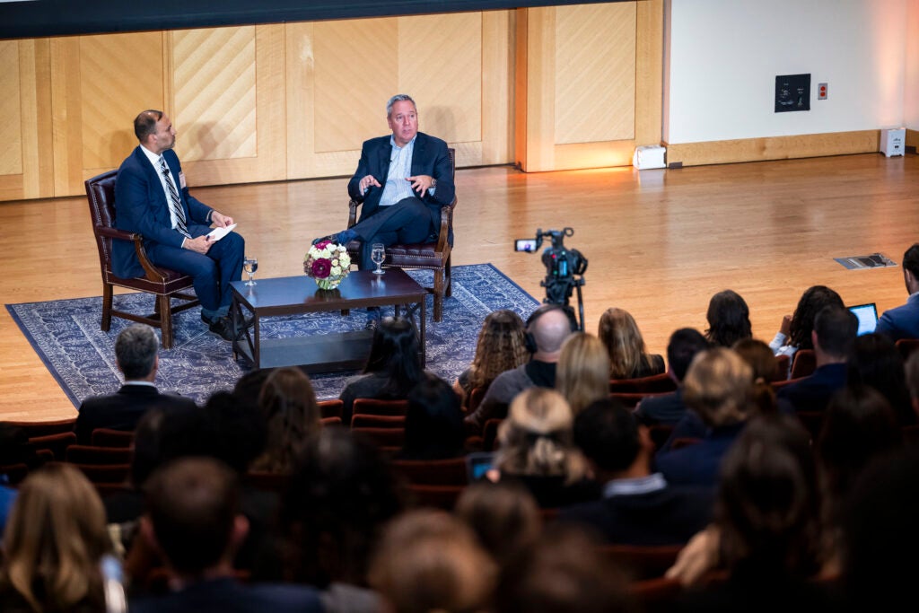 Bob Holycross of Ford Motor Companies (center stage) talks with Safak Yucel (left)
