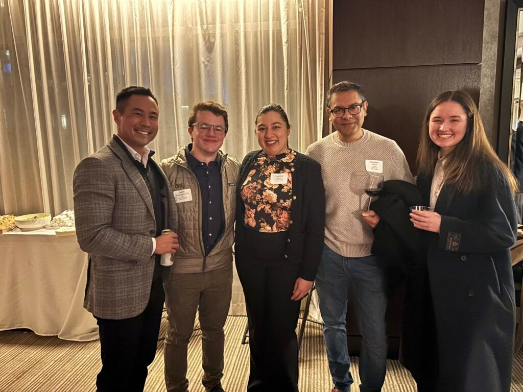 Five Georgetown alum stand shoulder-to-shoulder at a Business of Health Initiative event in San Francisco, California