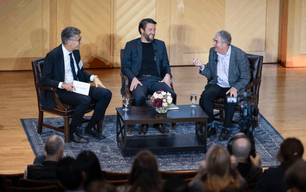 Three speakers on Lohrfink Auditorium stage at Georgetown McDonough's Leadership and Innovation Summit