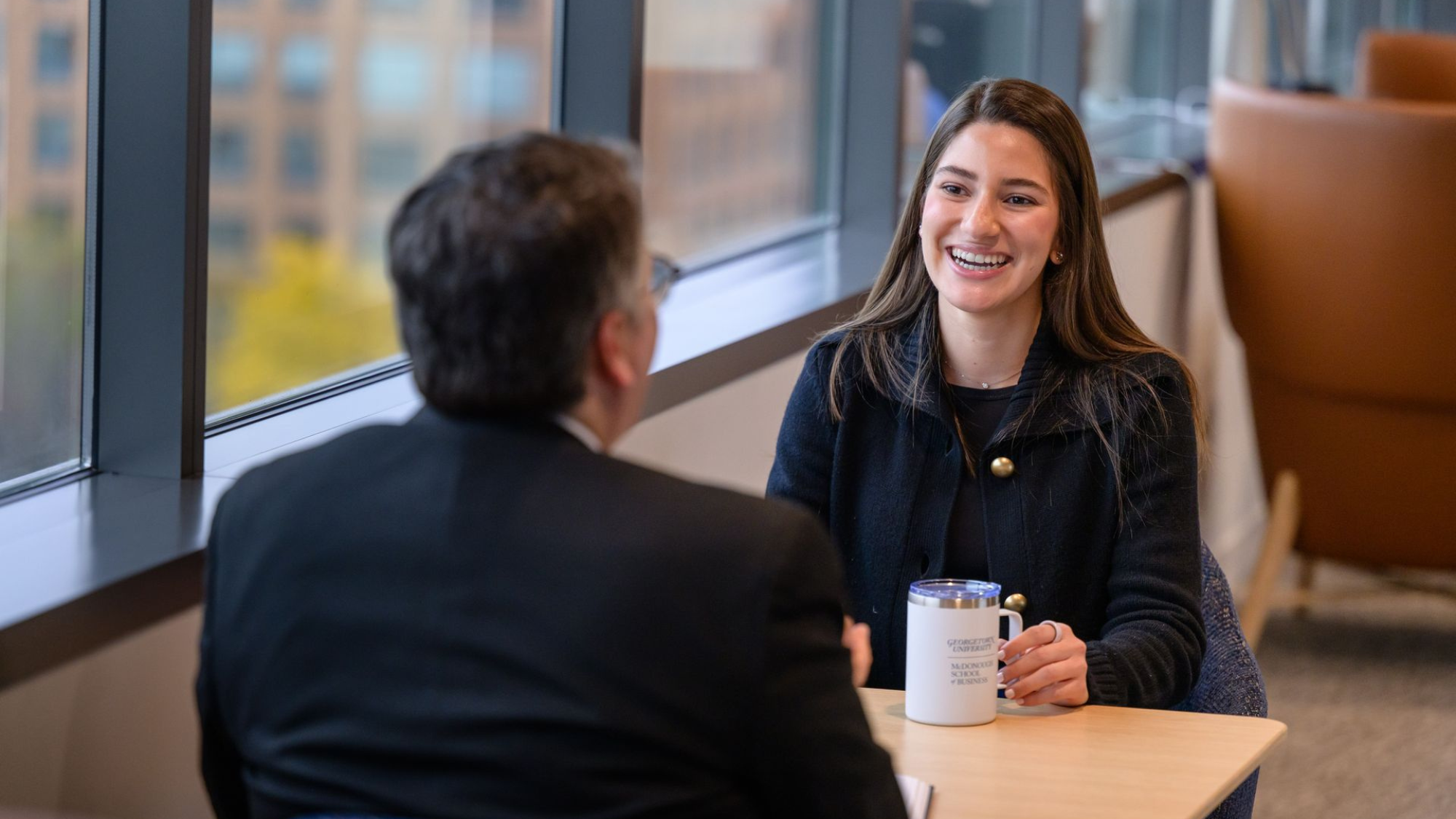 Georgetown Master's in Management student speaking with the admissions team at the Capitol Campus in Washington, D.C.