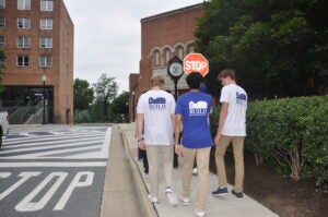 Three BUILD students walking outside on the Georgetown campus.