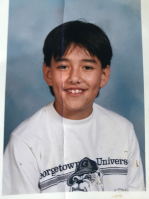 Luis Maes wearing a Georgetown University Bulldogs shirt as a young boy