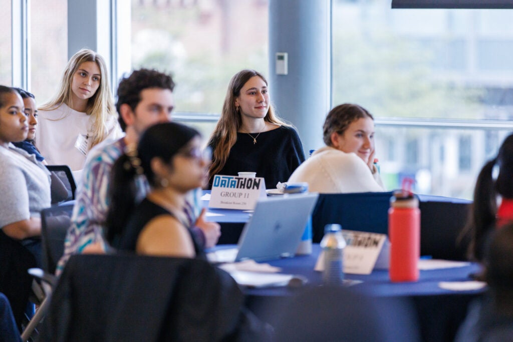 Georgetown students sitting around tables in Fisher Colloquium