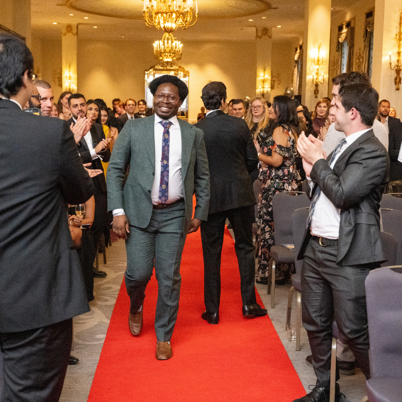 MBA graduate walking up to accept an award at the 2026 Gala