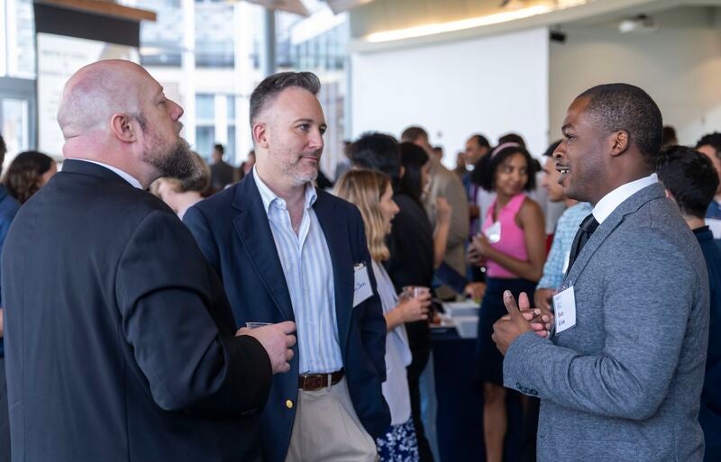 Dom Livas (MSBA'26) networking with peers at an MSBA social event.