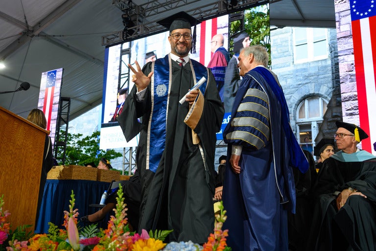 Graduate crosses stage