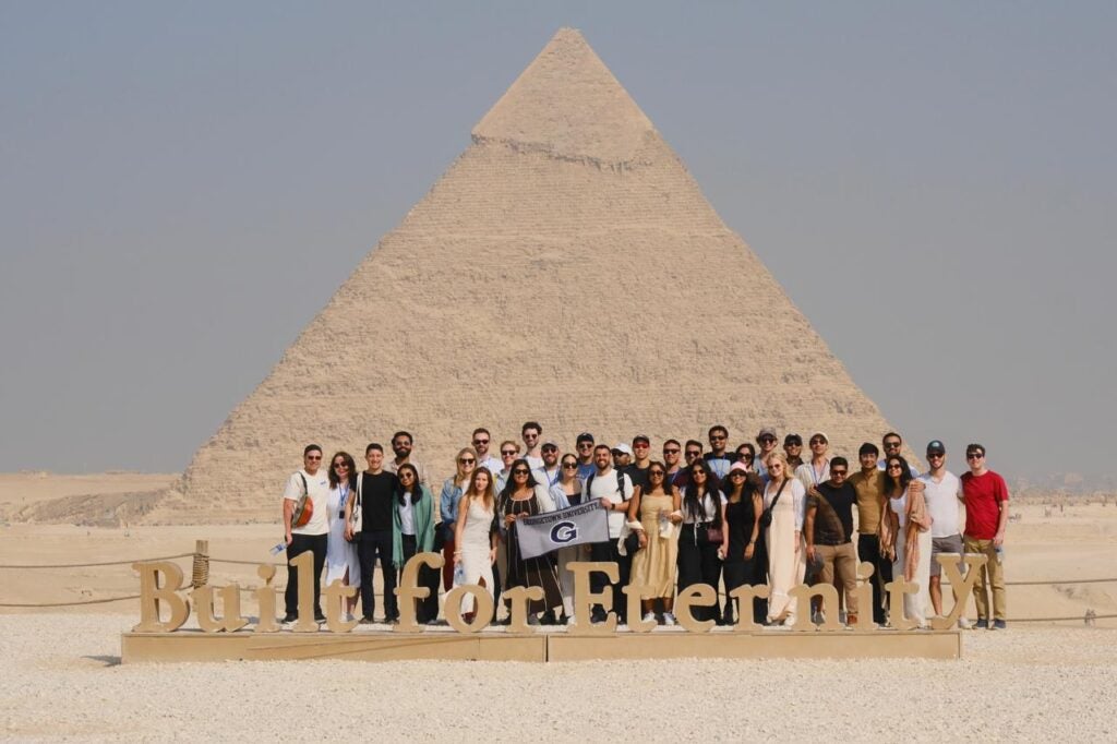 Georgetown Trek students in front of a pyramid in Egypt.