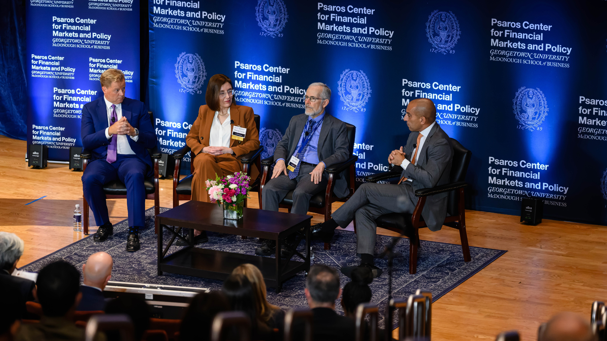 Four panelists on stage at Georgetown's Psaros Center's FMQ conference
