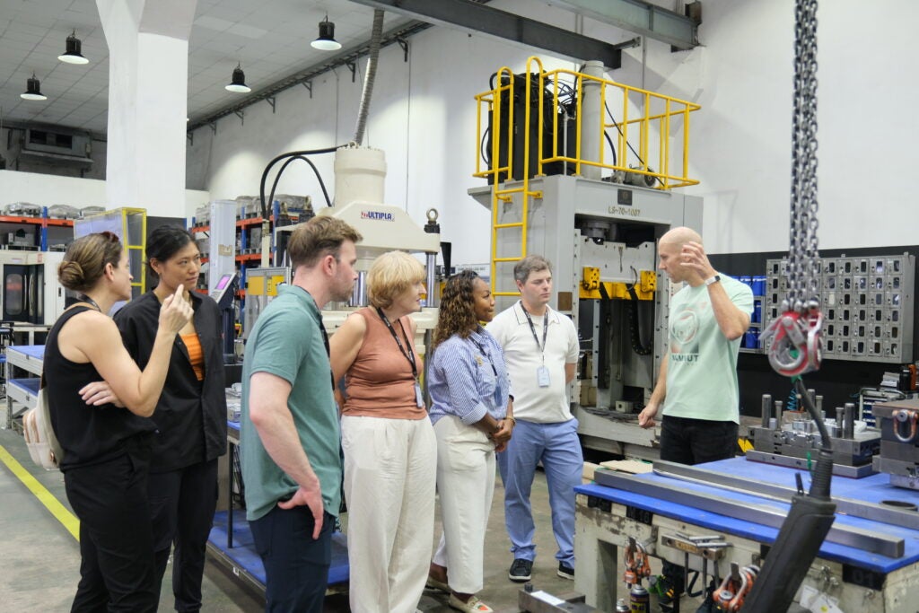 Aja Flewelen and the Executive MBA team receives a tour of the footwear technology manufacturing company during the Global Business Experience trips. 