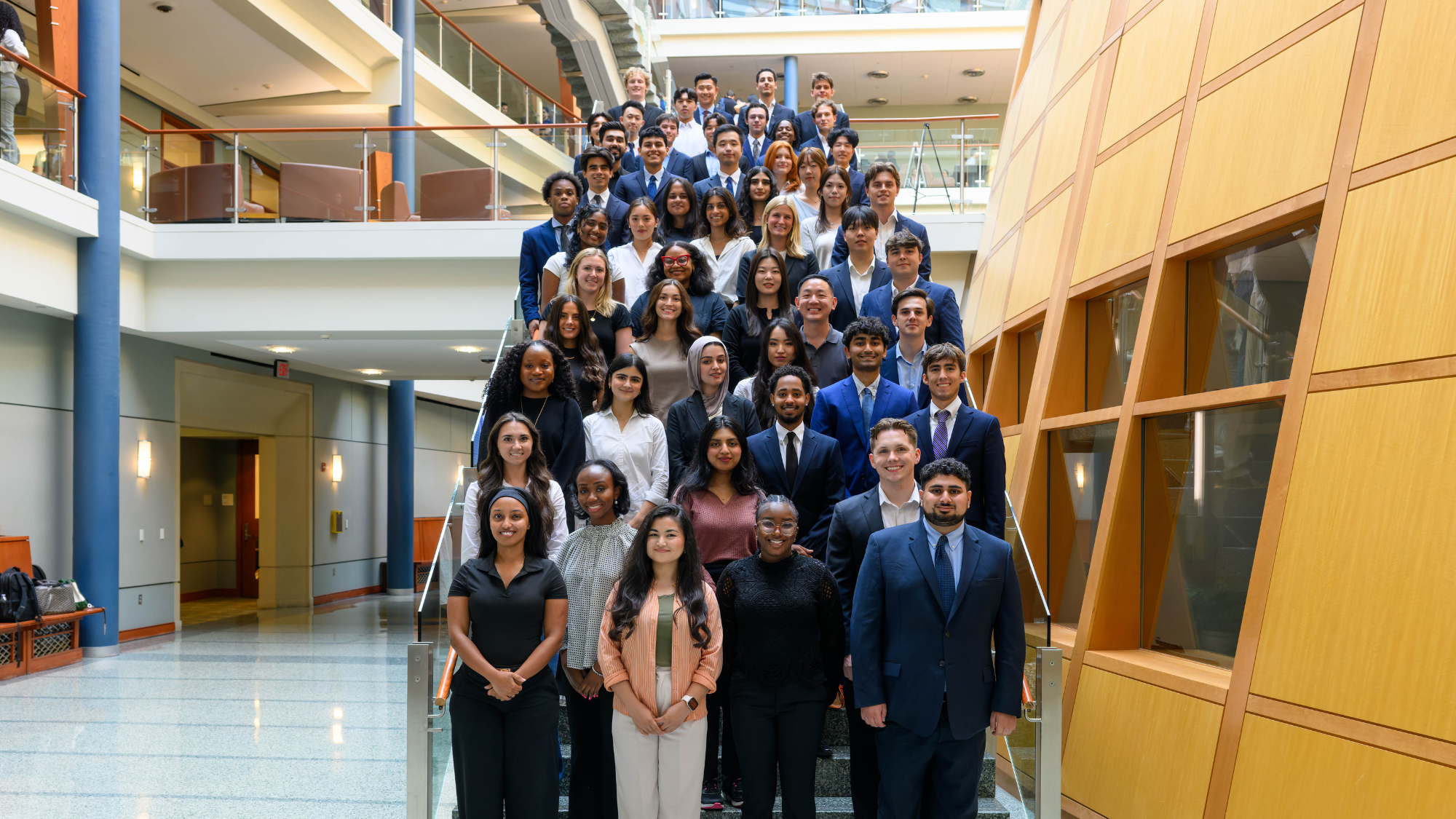 Inaugural Full-time M.S. in Business Analytics cohort posed on the staircase in the Rafik B. Hariri Building at Georgetown's McDonough School of Business