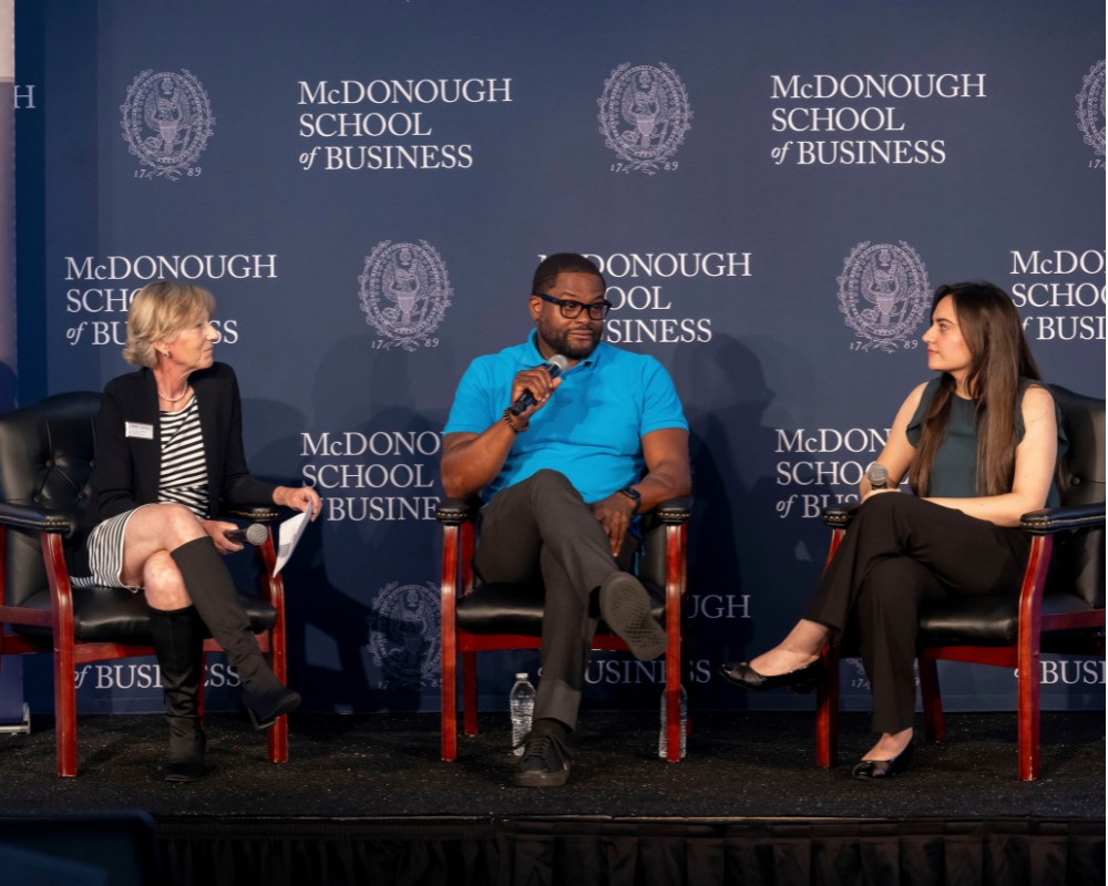 Executive Director of the Georgetown Pivot Program Alyssa Lovegrove speaks with Pivot Fellow Talib Shakir and Small Business Corps Fellow Shivika Sachdev (MBA’27) during the launch celebration.